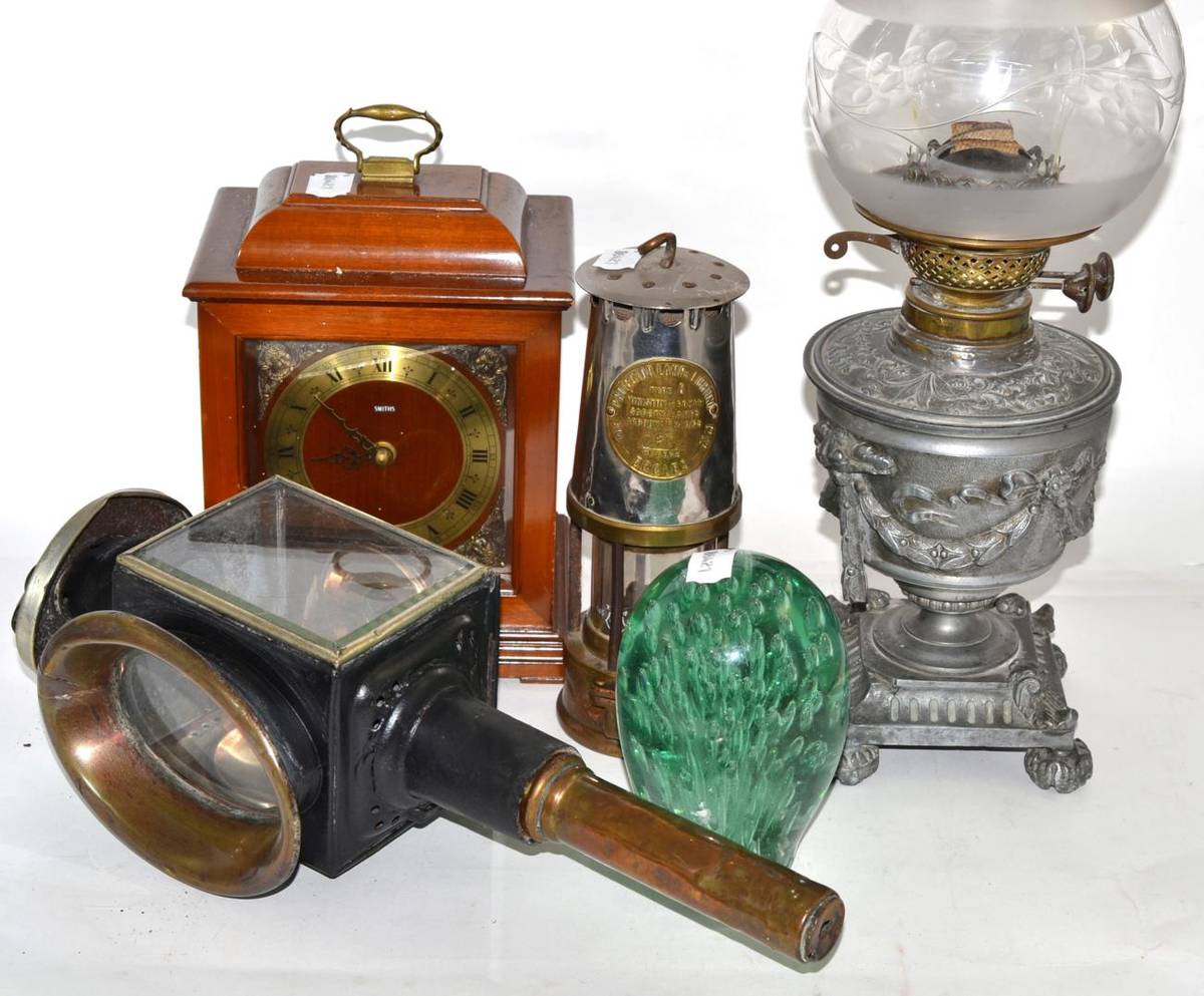 Lot 460 - A 19th century oil lamp, carriage lamp, miners lamp, glass dump paperweight and mantel timepiece