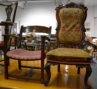 Lot 1067 - Victorian carved oak hall chair with needlework seat and back, together with an elbow chair (2)