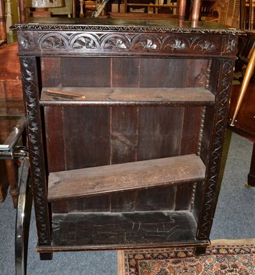 Lot 1075 - A late Victorian carved oak bookcase, with lunette carved frieze above carved stiles with...