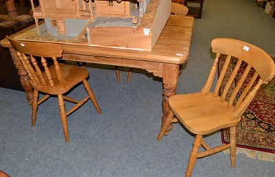 Lot 1079 - A pine kitchen table and four chairs