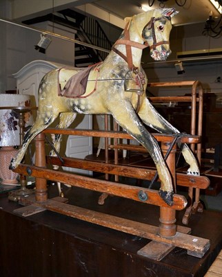 Lot 1080 - Painted wooden rocking horse on trestle base