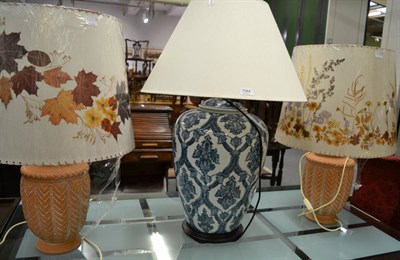 Lot 1084 - A Chinese style large ceramic table lamp; a pair of unglazed ceramic vase table lamps and three...