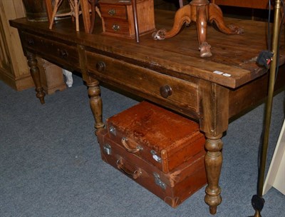 Lot 1093 - A large pine farmhouse plank top table, two drawers, turned baluster legs, 230cm in length