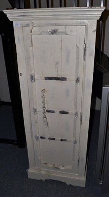 Lot 1108 - A shabby chic cream painted cabinet, the cupboard door with metal straps and chain enclosing...