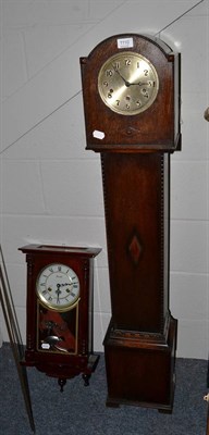 Lot 1110 - A small chiming longcase clock and a modern striking wall clock (2)