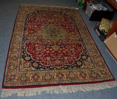 Lot 1119 - An Indian rug of Isaphan design, the raspberry field of vines around a central medallion, framed by