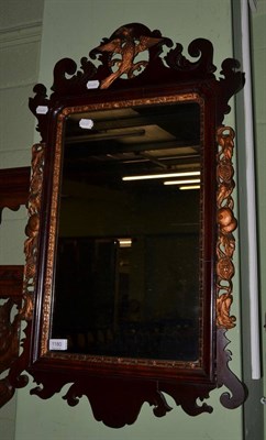 Lot 1180 - A parcel gilt mahogany fret work mirror surmounted by a ho-ho bird