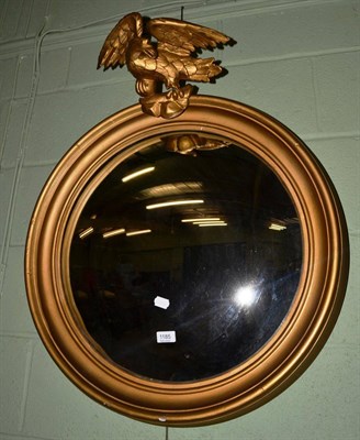 Lot 1185 - A Regency style convex wall mirror in moulded gilt frame, eagle finial