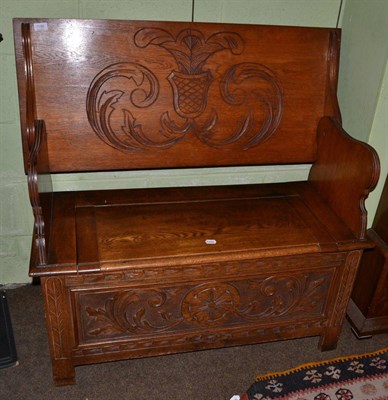 Lot 1186 - An early 20th century carved oak monks bench