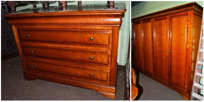 Lot 1190 - A cherrywood bedroom suite comprising a chest of drawers and a four door wardrobe