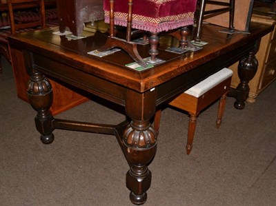 Lot 1203 - An oak dining table