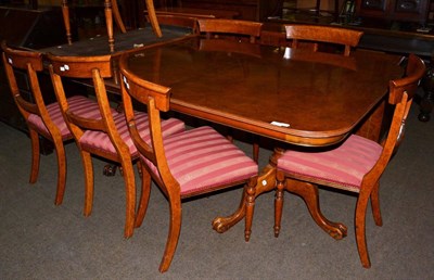 Lot 1211 - A reproduction burr walnut twin-pedestal extending dining table of recent date, with two...