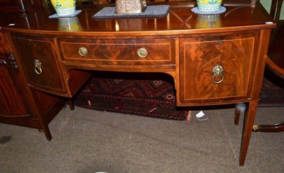 Lot 1225 - A 19th century checkered string inlaid mahogany bow fronted sideboard, with brass gallery