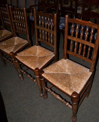 Lot 1228 - Set of four rush seated spindle back country chairs