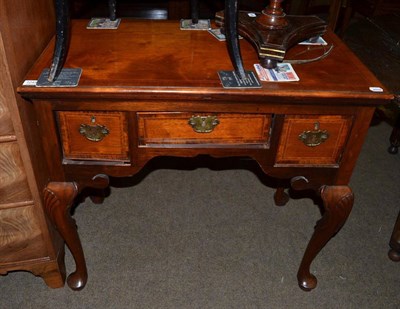 Lot 1245 - A reproduction figured walnut, crossbanded and feather banded lowboy, on shell-carved cabriole...