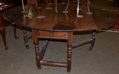 Lot 1248 - An early 18th century joined oak six-seater gateleg table, raised on spindle turned legs joined...