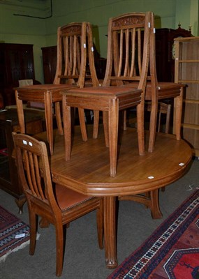 Lot 1252 - An oak extending table with six matching chairs upholstered in close nailed leather