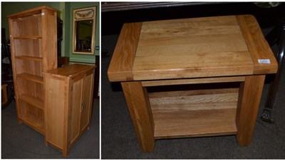 Lot 1257 - Three items of modern oak furniture comprising a tall open bookcase, square table and two door...