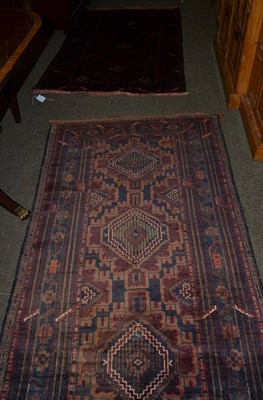 Lot 1275 - An Afghan rug, North Afghanistan, the charcoal field with three stepped medallions enclosed by...