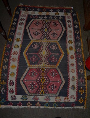 Lot 1276 - An Anatolian Kilim, the field with three hexagonal enclosed by double borders, 138cm by 100cm