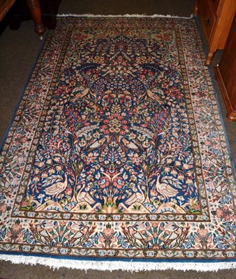 Lot 1279 - Kirman prayer rug, South East Iran, the sky blue field of birds and vines beneath the Mihrab framed