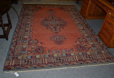 Lot 1285 - Khotan carpet, East Turkestan, the terracotta field with central medallion framed by spandrels...