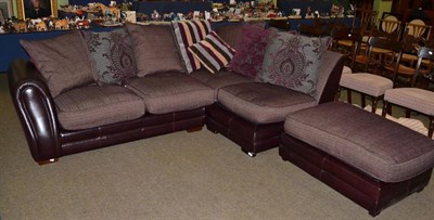 Lot 1293 - A leather and red fabric four-seater corner sofa, with scatter cushions, maximum width 260cm; and a