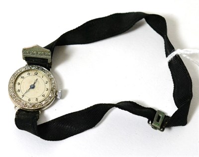 Lot 23 - A lady's diamond set cocktail watch, on a black fabric strap, case stamped 'platine'