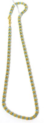 Lot 37 - A faceted blue bead and yellow bead necklace, stamped '750', 42cm long