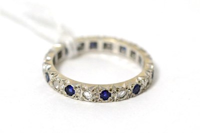 Lot 38 - A sapphire and diamond eternity ring, stamped '18CT', finger size M