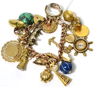 Lot 43 - A charm bracelet with a 9 carat gold padlock, a soldered half sovereign, a 9 carat gold charm...