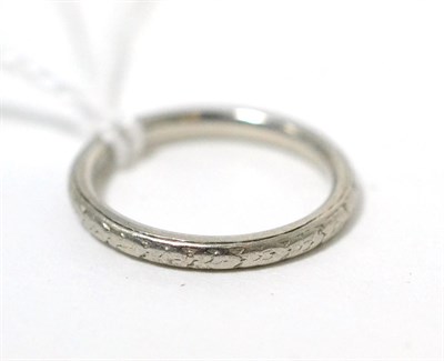 Lot 59 - A floral engraved band ring, finger size K, stamped 'PLATINUM'