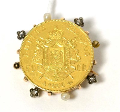 Lot 65 - An 1856 French 50 Franc coin, in a diamond and seed pearl set frame as a brooch (losses to frame)