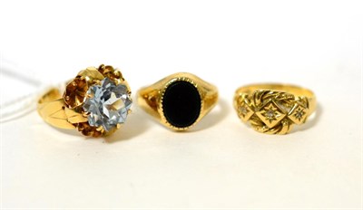 Lot 89 - A blue topaz ring, a 9 carat gold signet ring and an 18 carat gold diamond ring (3)