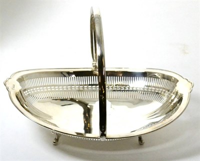 Lot 251 - A silver swing handled basket, Sheffield, 1925, of pierced navette form, raised on four feet