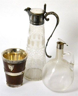 Lot 256 - An Edwardian glass claret jug with unusual ribbed body, another claret jug with electroplated mount