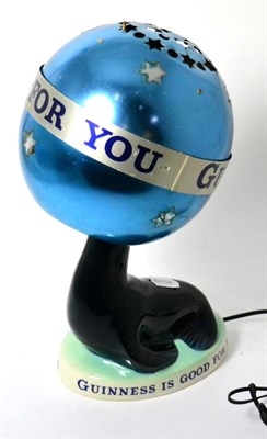 Lot 264 - A Carlton Ware seal Guinness table lamp with shade, base marked 'Guinness is good for you'