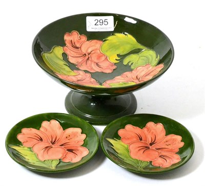 Lot 295 - Walter Moorcroft coral Hibiscus comport and two pin dishes, on a green ground (3)