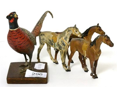 Lot 296 - A cold painted bronze model of a pheasant and a painted metal model of three horses