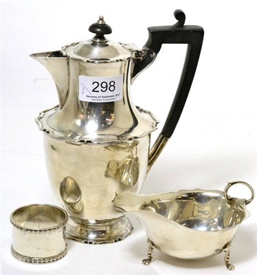 Lot 298 - A silver hot water jug, sauce boat and napkin ring