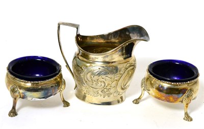 Lot 303 - A George III silver cream jug and a pair of circular open salts, glass liners