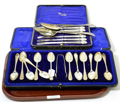 Lot 305 - Two silver table spoons, six silver handled knives and a set of twelve bright cut silver spoons...