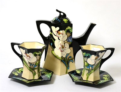 Lot 323 - A Moorcroft teapot ";Au lait"; pattern (first) together with two matching cups and saucers...