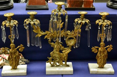 Lot 341 - A three piece gilt metal garniture with figural support, on marble base