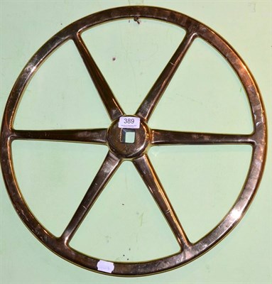 Lot 389 - A solid brass ships wheel