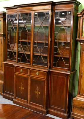 Lot 1122 - An inlaid mahogany breakfront astragal glazed bookcase cabinet