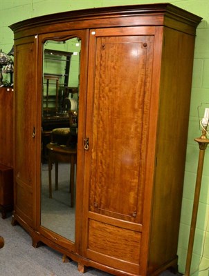 Lot 1129 - Mahogany bow fronted mirrored triple wardrobe