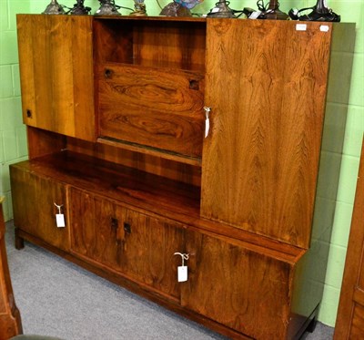 Lot 1130 - A 1960's Danish rosewood veneered wall unit, the upper section with open central compartment, above