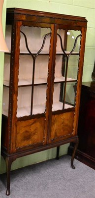 Lot 1134 - An early 20th century mahogany display cabinet, astragal glazed doors and sides, cabriole legs