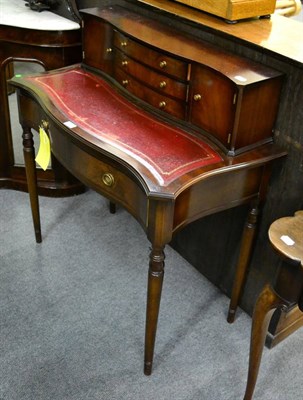 Lot 1151 - A reproduction mahogany writing table with super structure back, leather writing surface above...